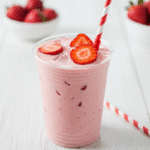 Copycat Starbucks Pink Drink 2 Homemade copycat Starbucks Pink Drink in a clear cup with fresh strawberries and ice
