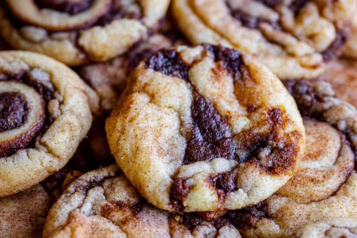 cinnamon-roll-cookies (3) Close-up of cinnamon roll cookies showing detailed cinnamon swirl pattern and soft chewy texture with cinnamon sugar coating